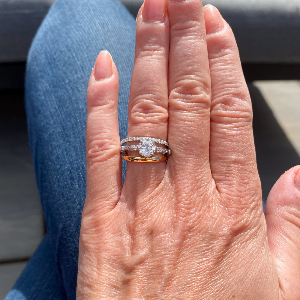 An Art Deco diamond engagement ring featuring a central round old cut diamond flanked by diamond-set shoulders on a silver-coloured metal band. View IX
