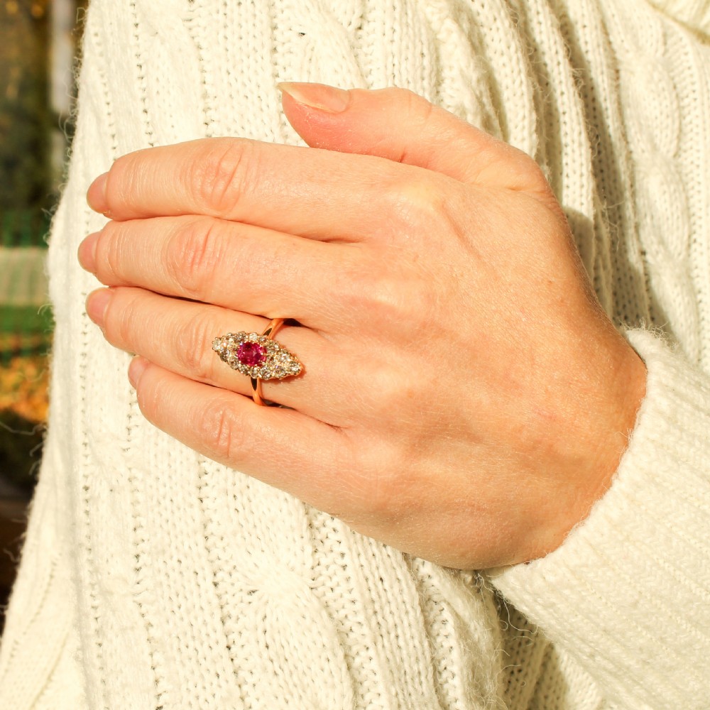 A late Victorian yellow gold navette cluster ring set with a central oval ruby surrounded by old cut diamonds. View VII