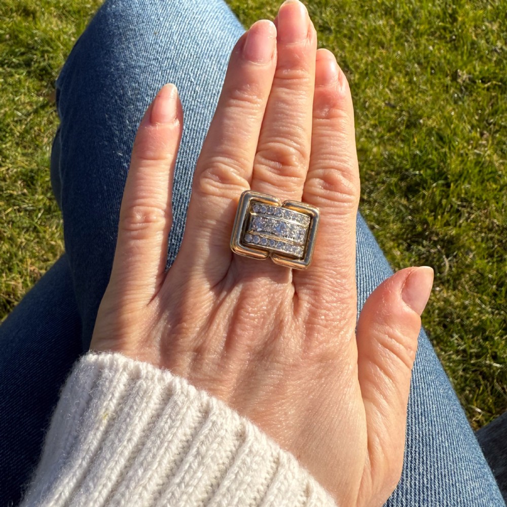 A mid-century yellow gold cocktail ring featuring a geometric rectangular front set with three horizontal rows of brilliant-cut diamonds. View VI