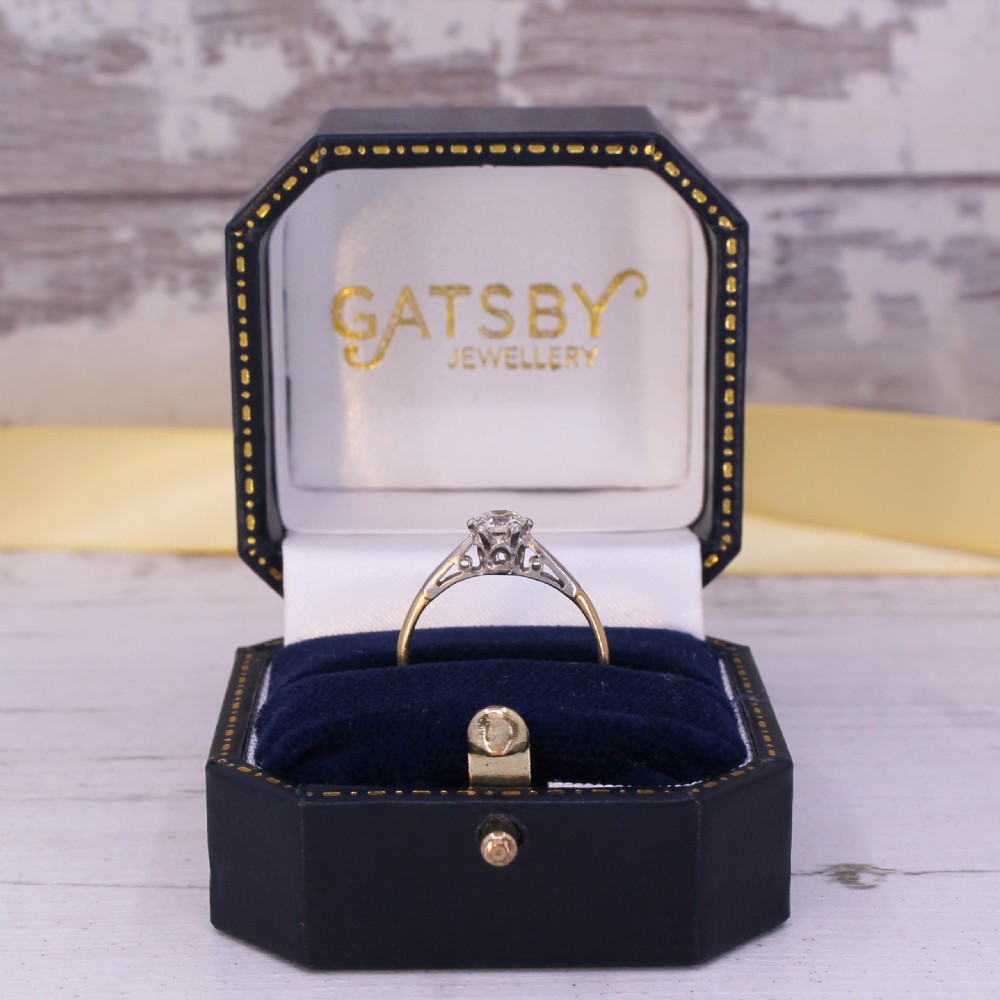 A mid-century engagement ring featuring a single old-cut diamond set in platinum shoulders on a yellow gold band. View X