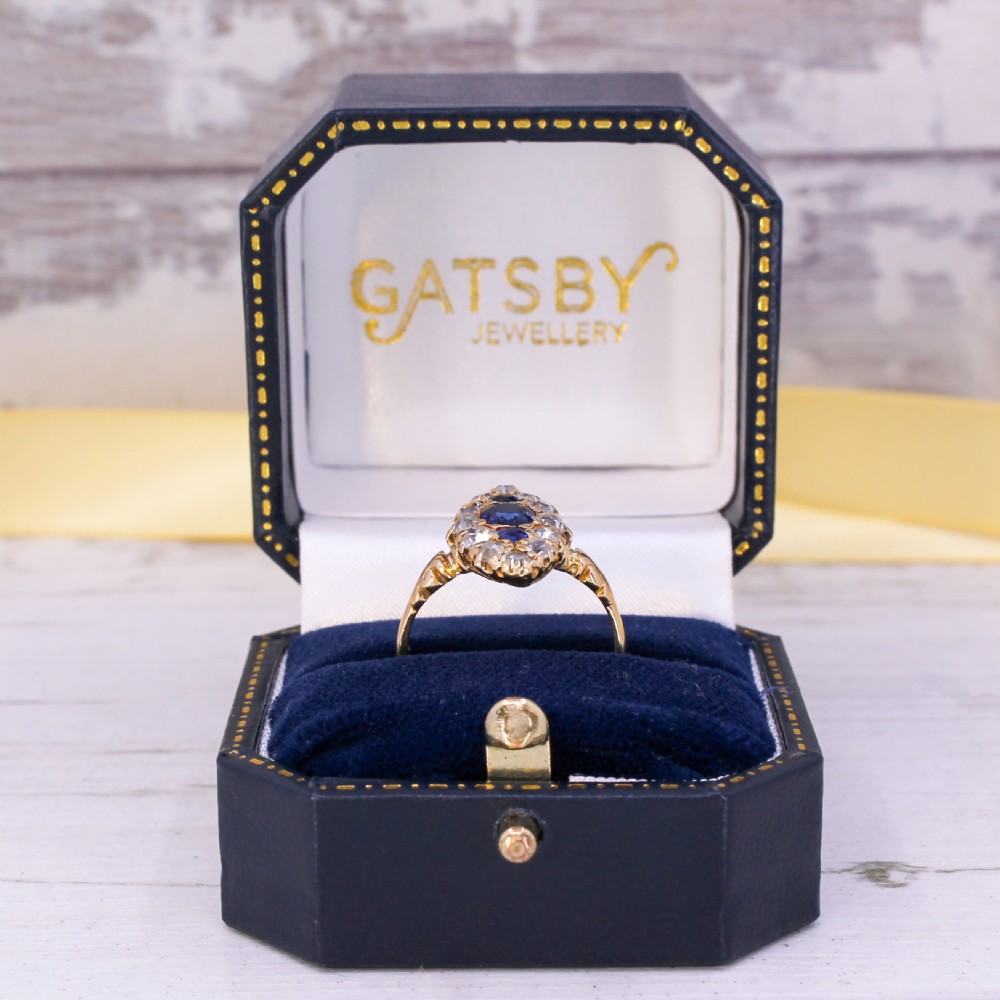 A late Victorian yellow gold ring featuring an elongated marquise cluster set with central blue sapphires surrounded by old cut diamonds. View IX
