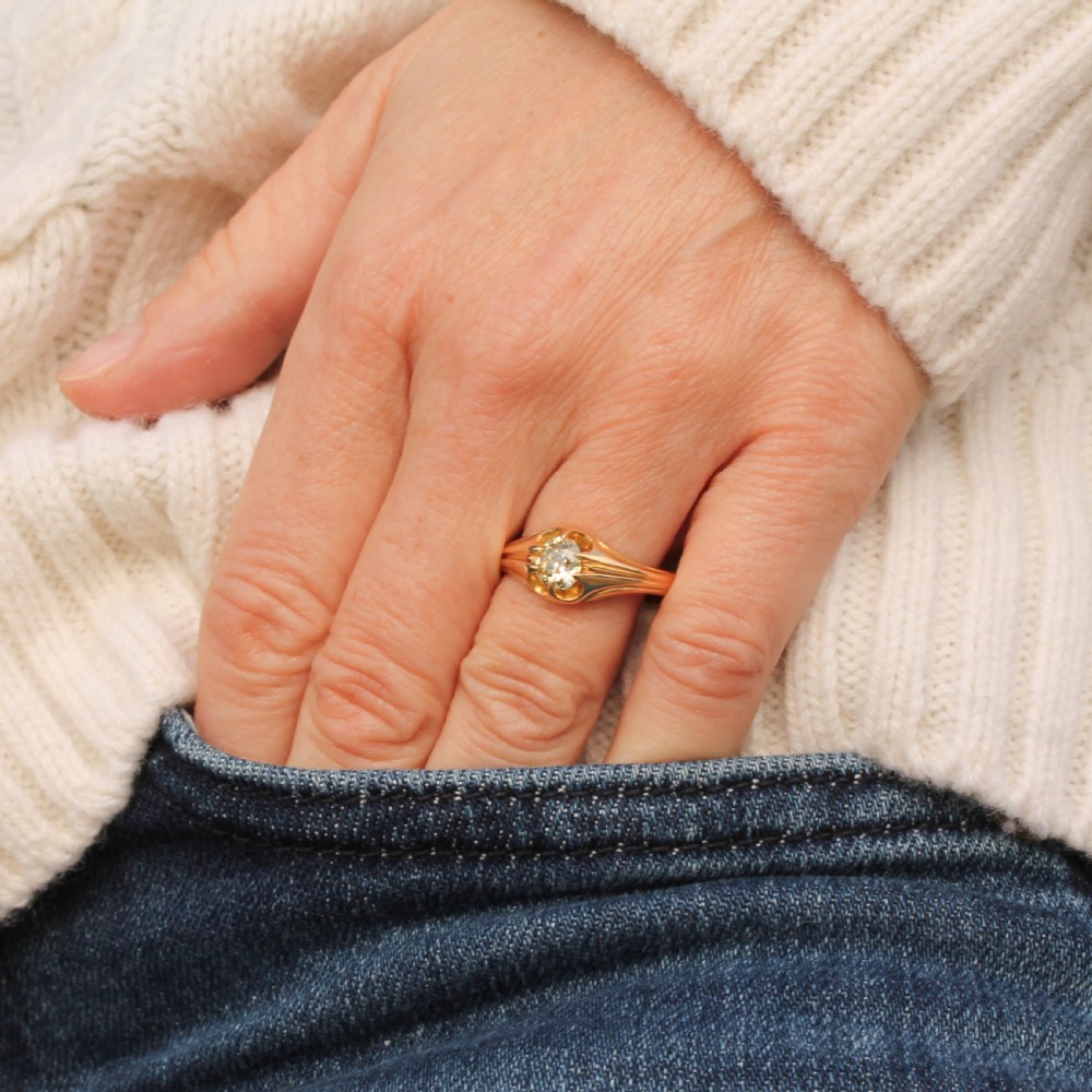 A late Victorian yellow gold ring featuring a single central antique cut fancy yellow diamond in a carved setting. View II