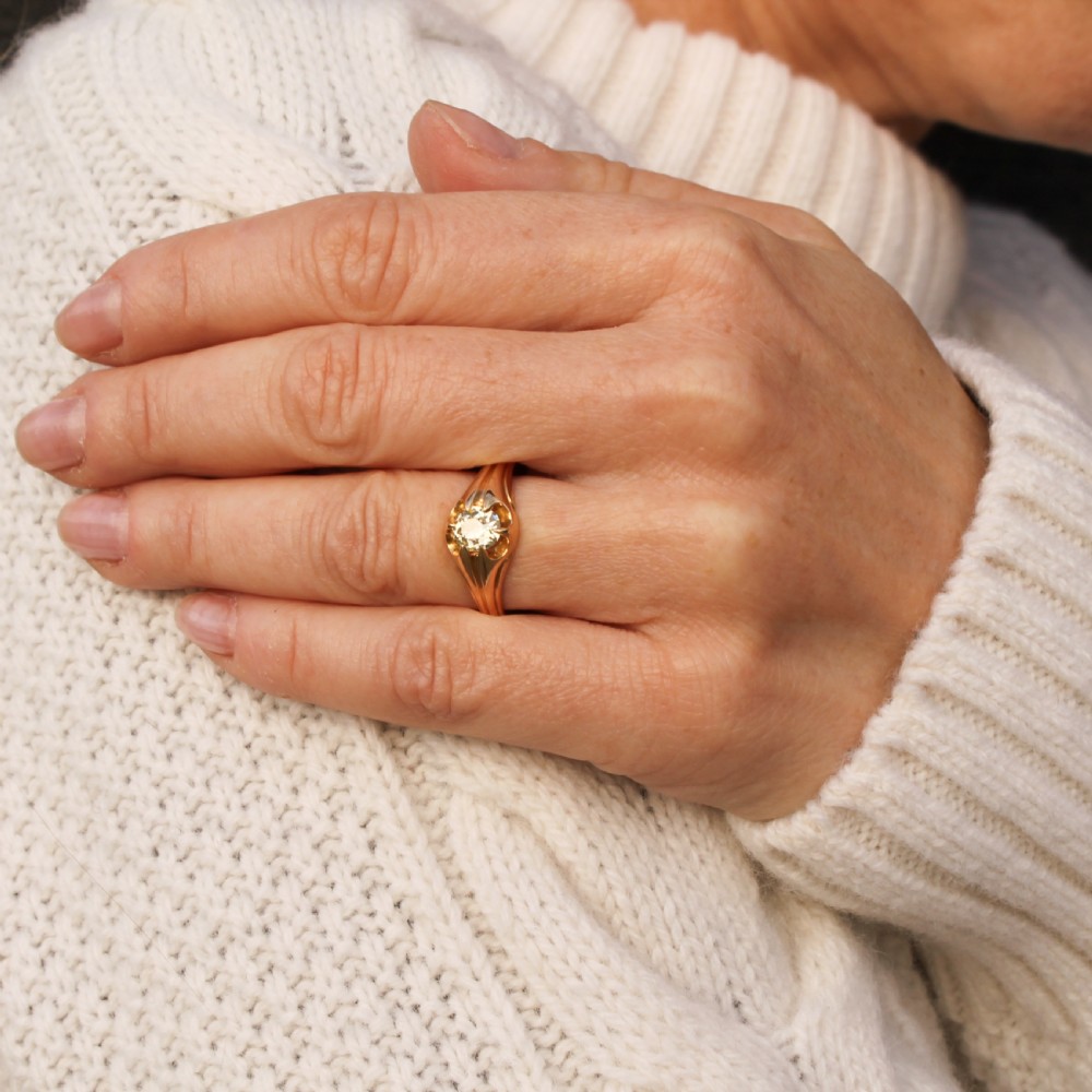 A late Victorian yellow gold ring featuring a single central antique cut fancy yellow diamond in a carved setting. View VIII