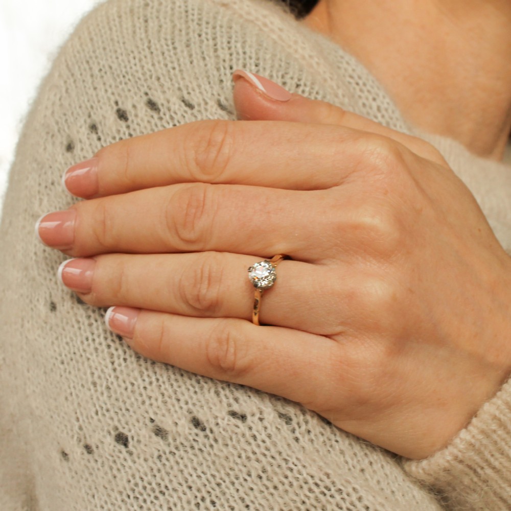 A vintage circa 1935 engagement ring featuring a single old cut diamond set in platinum claws on a slender yellow gold band. View II