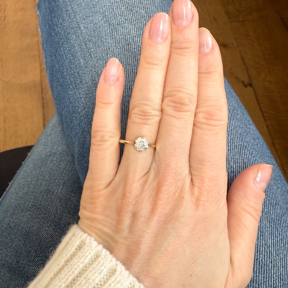 A vintage circa 1935 engagement ring featuring a single old cut diamond set in platinum claws on a slender yellow gold band. View VI