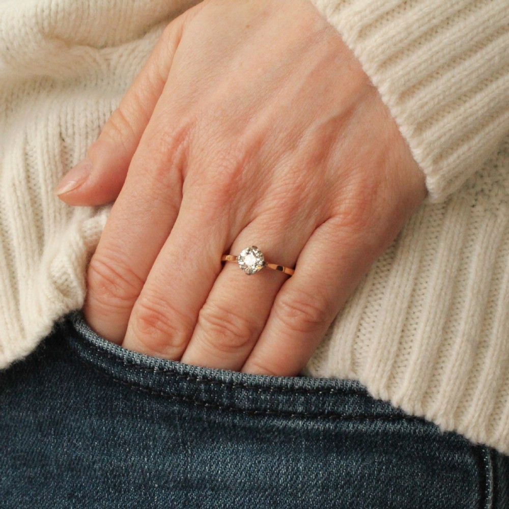 A vintage circa 1935 engagement ring featuring a single old cut diamond set in platinum claws on a slender yellow gold band. View VII