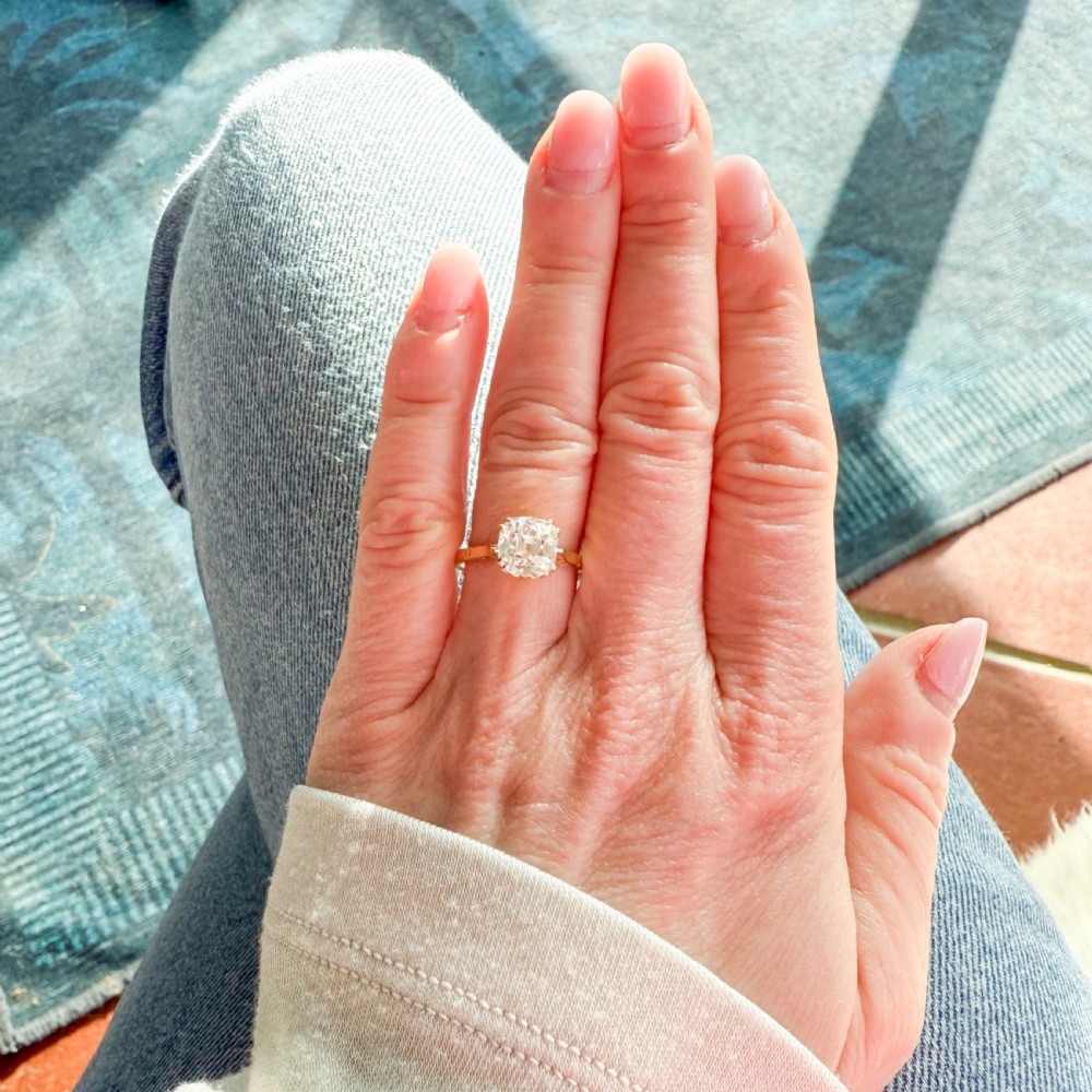 An antique yellow gold solitaire ring featuring a cushion-shaped old cut diamond in a claw setting. View VI