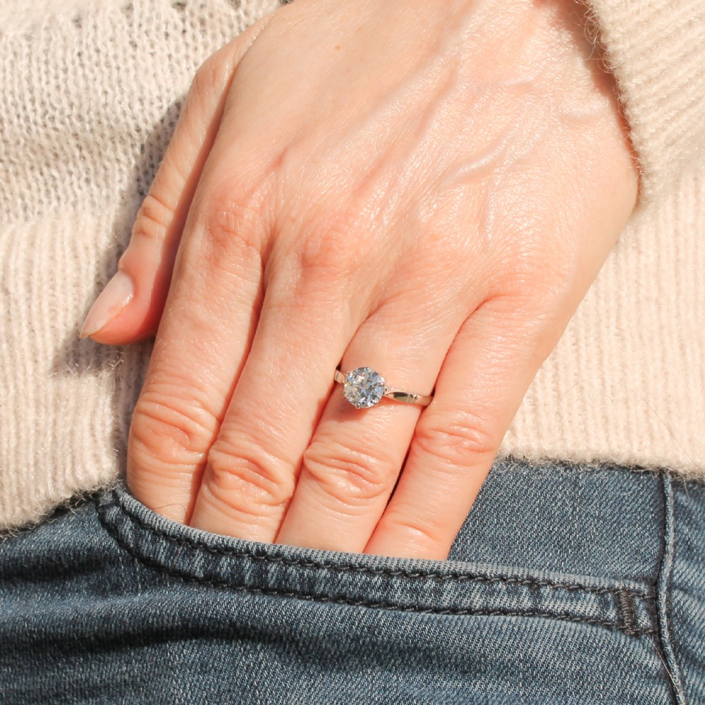 An antique platinum solitaire ring set with a single round old-cut diamond in a six-claw setting. View II