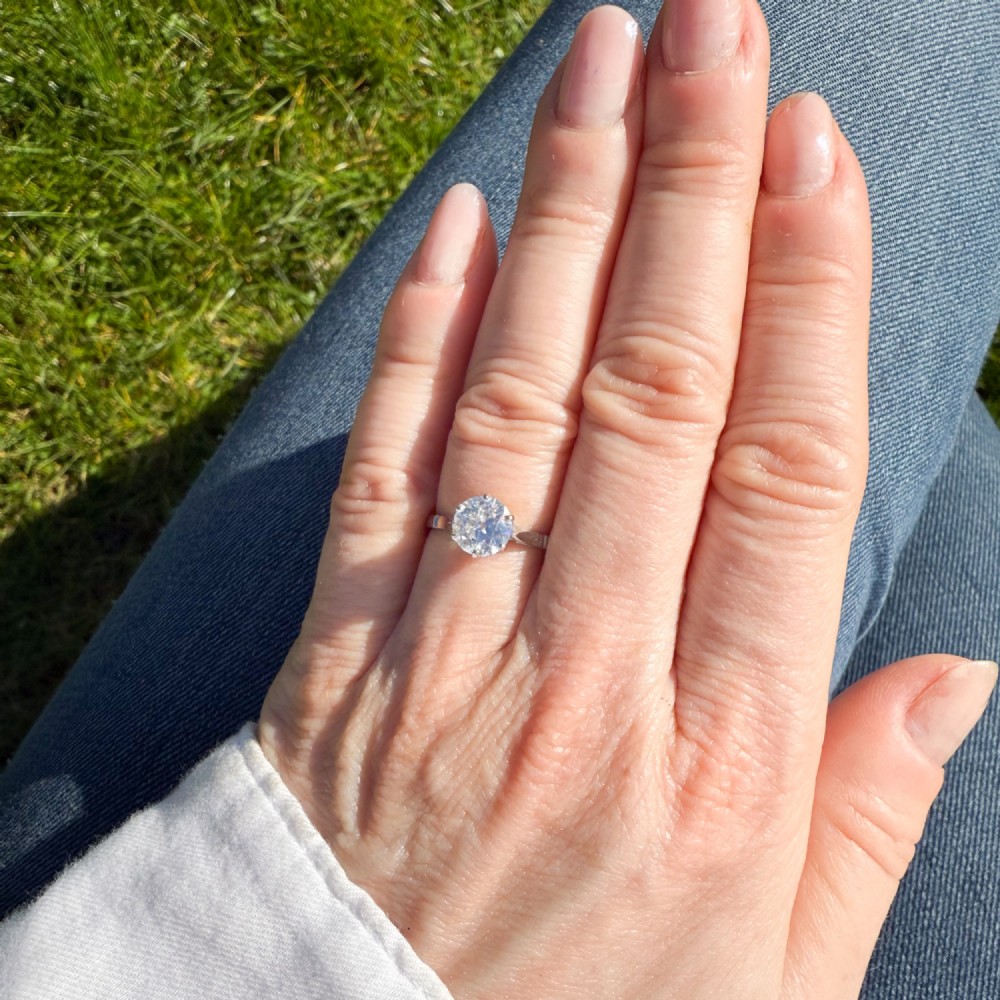 An antique platinum solitaire ring set with a single round old-cut diamond in a six-claw setting. View VI