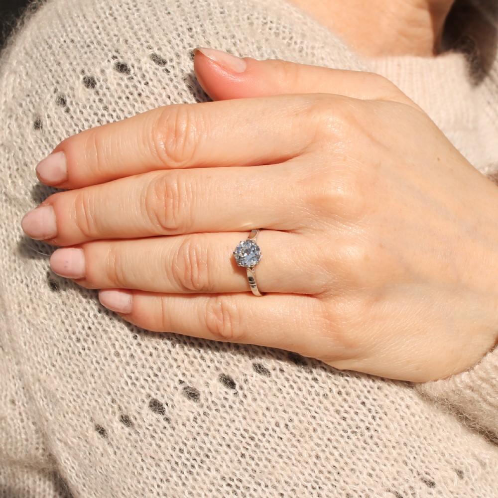An antique platinum solitaire ring set with a single round old-cut diamond in a six-claw setting. View VII