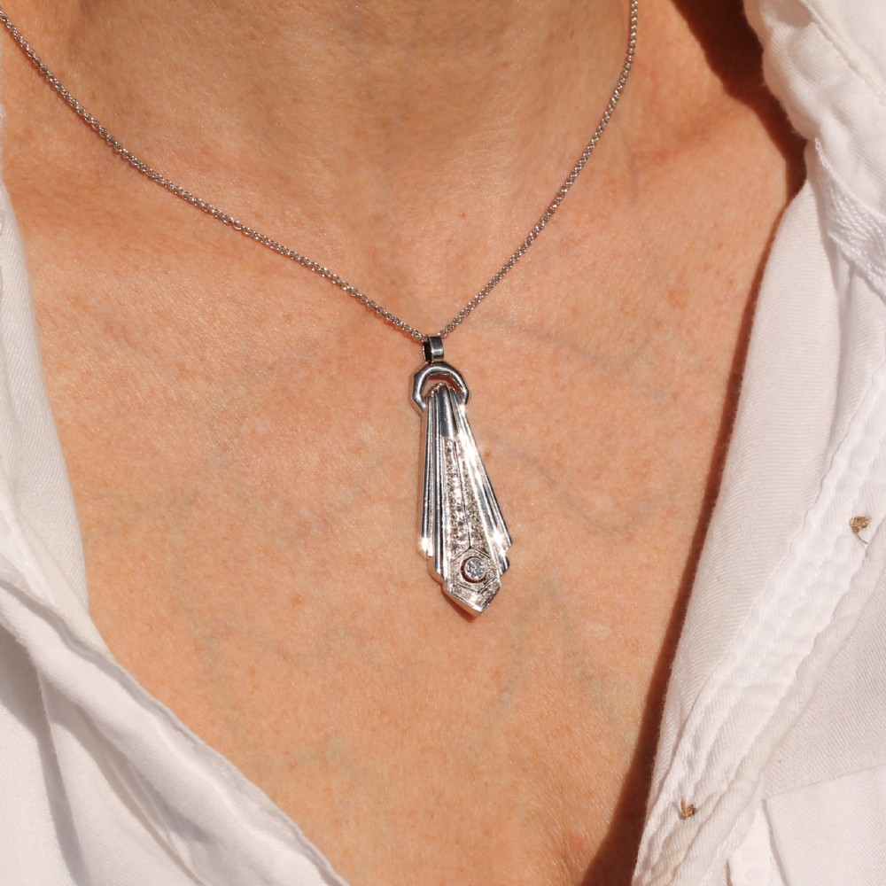 An Art Deco diamond drop pendant featuring geometric fluted metalwork set with brilliant-cut diamonds on a fine silver chain. View II