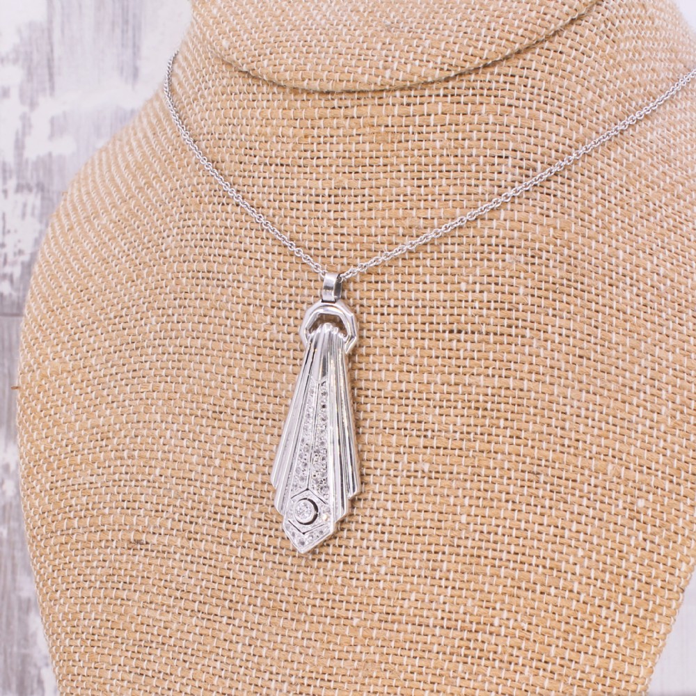 An Art Deco diamond drop pendant featuring geometric fluted metalwork set with brilliant-cut diamonds on a fine silver chain. View III