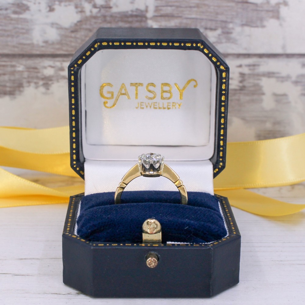 A vintage yellow gold engagement ring featuring a central old cut diamond set in a six-claw platinum head with stepped shoulders. View IX