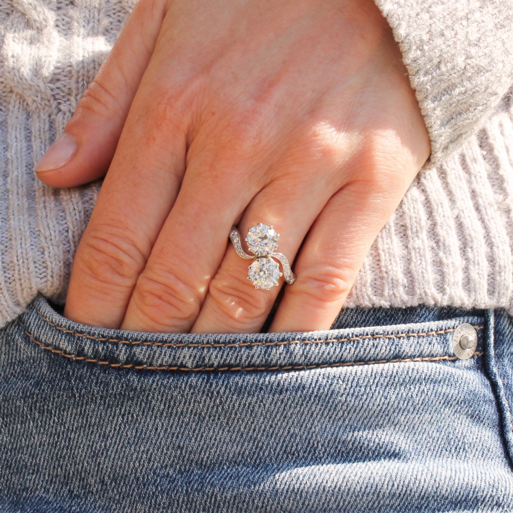 A vintage two-stone diamond Toi et Moi ring featuring two old European cut diamonds set in claw settings with a yellow gold band and diamond-paved shoulders. View VII