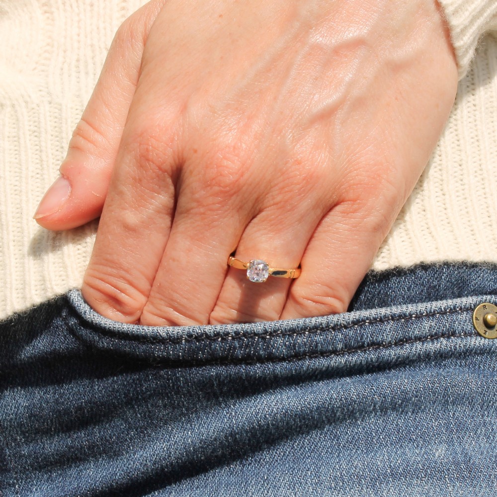 A yellow gold solitaire ring featuring a central cushion shaped old cut diamond with geometric shoulder accents. View II