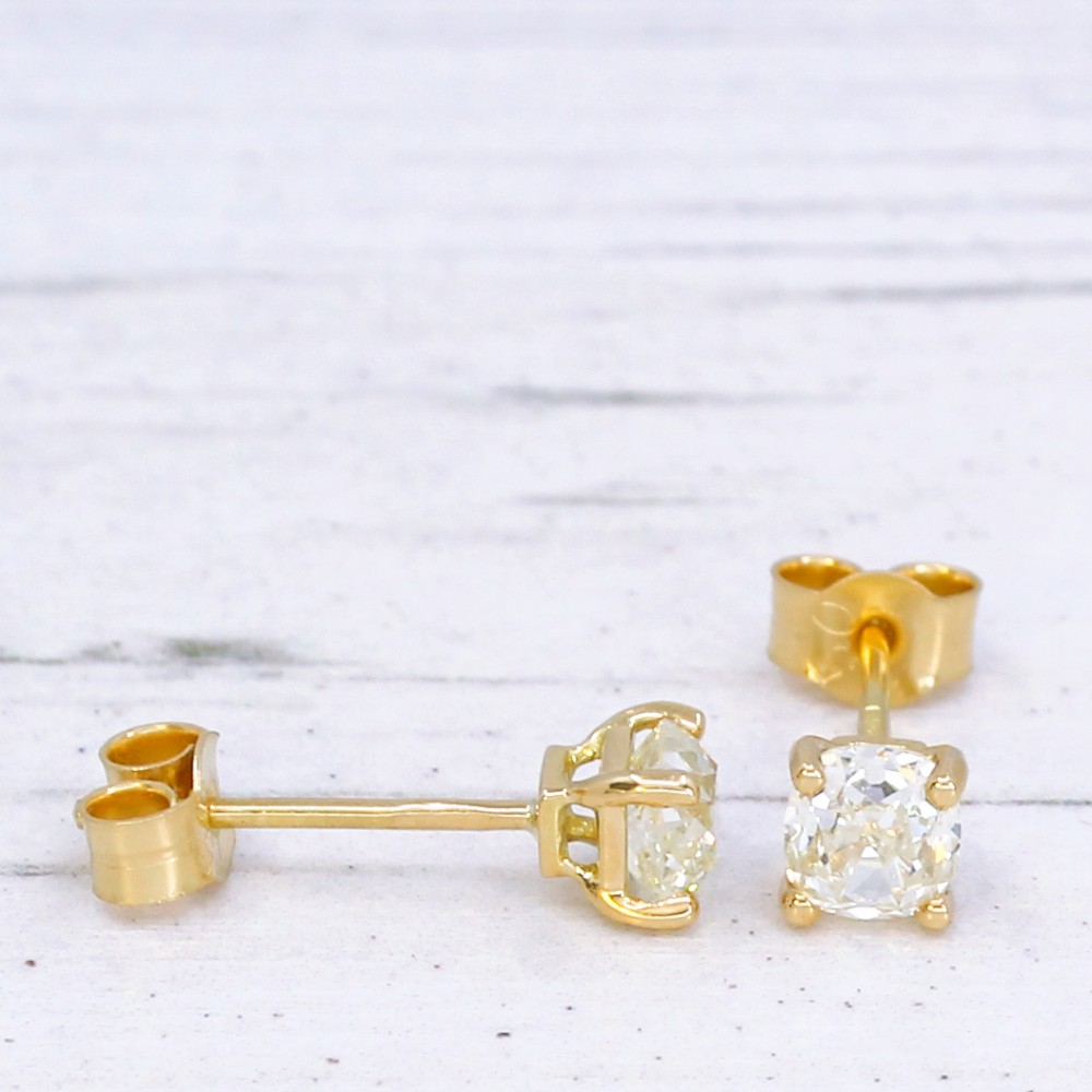 A pair of 18k yellow gold stud earrings featuring claw-set old mine cut diamonds. View V