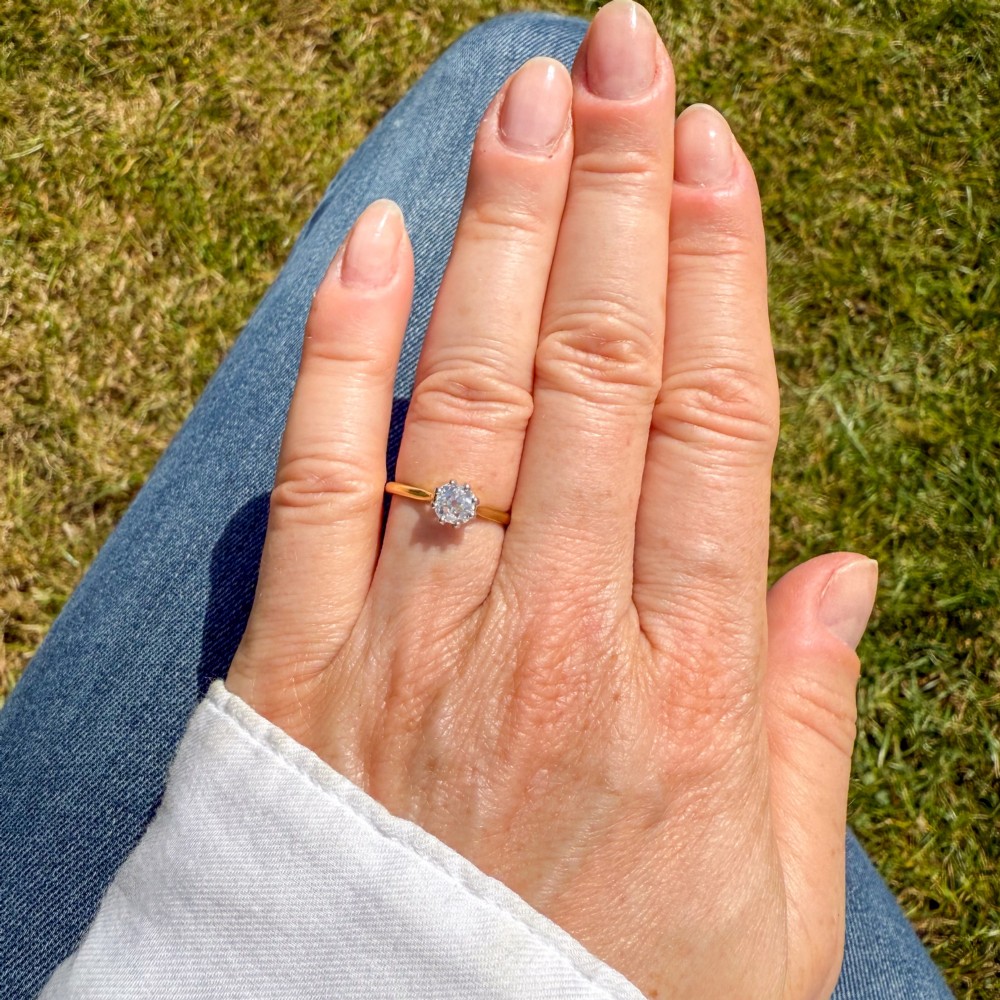 A 1920s engagement ring featuring a single old cut diamond held in a six-claw white metal setting on a slender yellow gold band. View VII