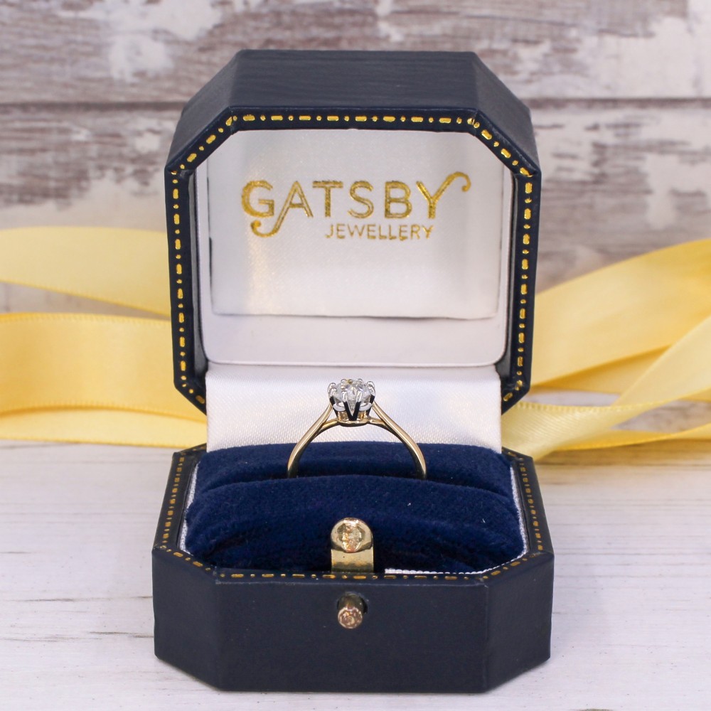 A 1920s engagement ring featuring a single old cut diamond held in a six-claw white metal setting on a slender yellow gold band. View IX