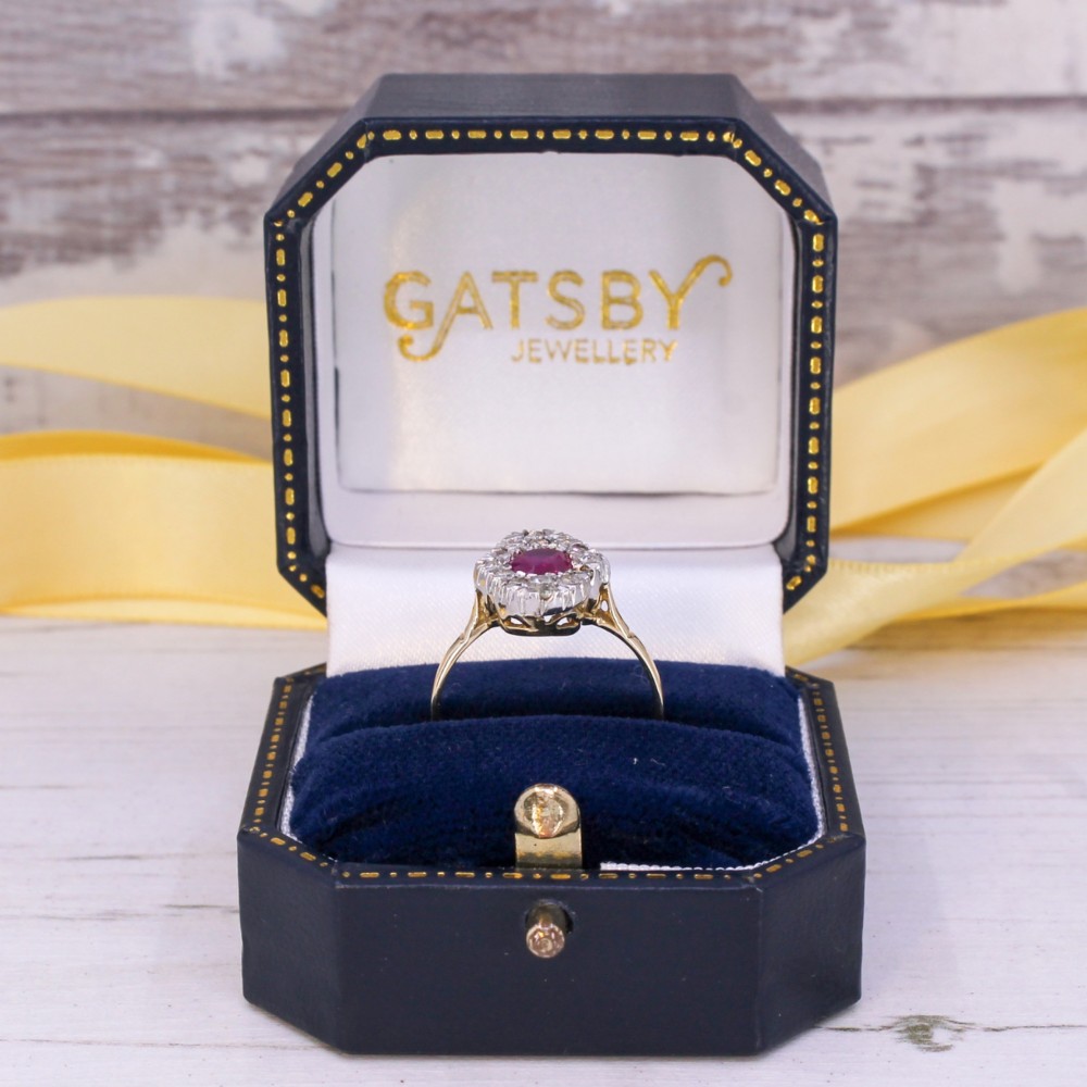 A Victorian ruby and diamond cluster ring featuring an oval red central ruby encased by old-cut diamonds on a yellow gold band. View VIII
