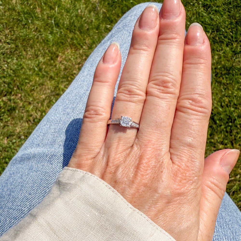 A vintage platinum engagement ring featuring a central old cut diamond flanked by diamond-set shoulders. View II