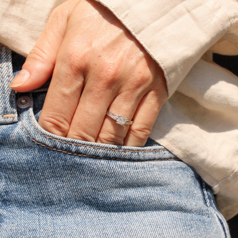 A vintage platinum engagement ring featuring a central old cut diamond flanked by diamond-set shoulders. View VII