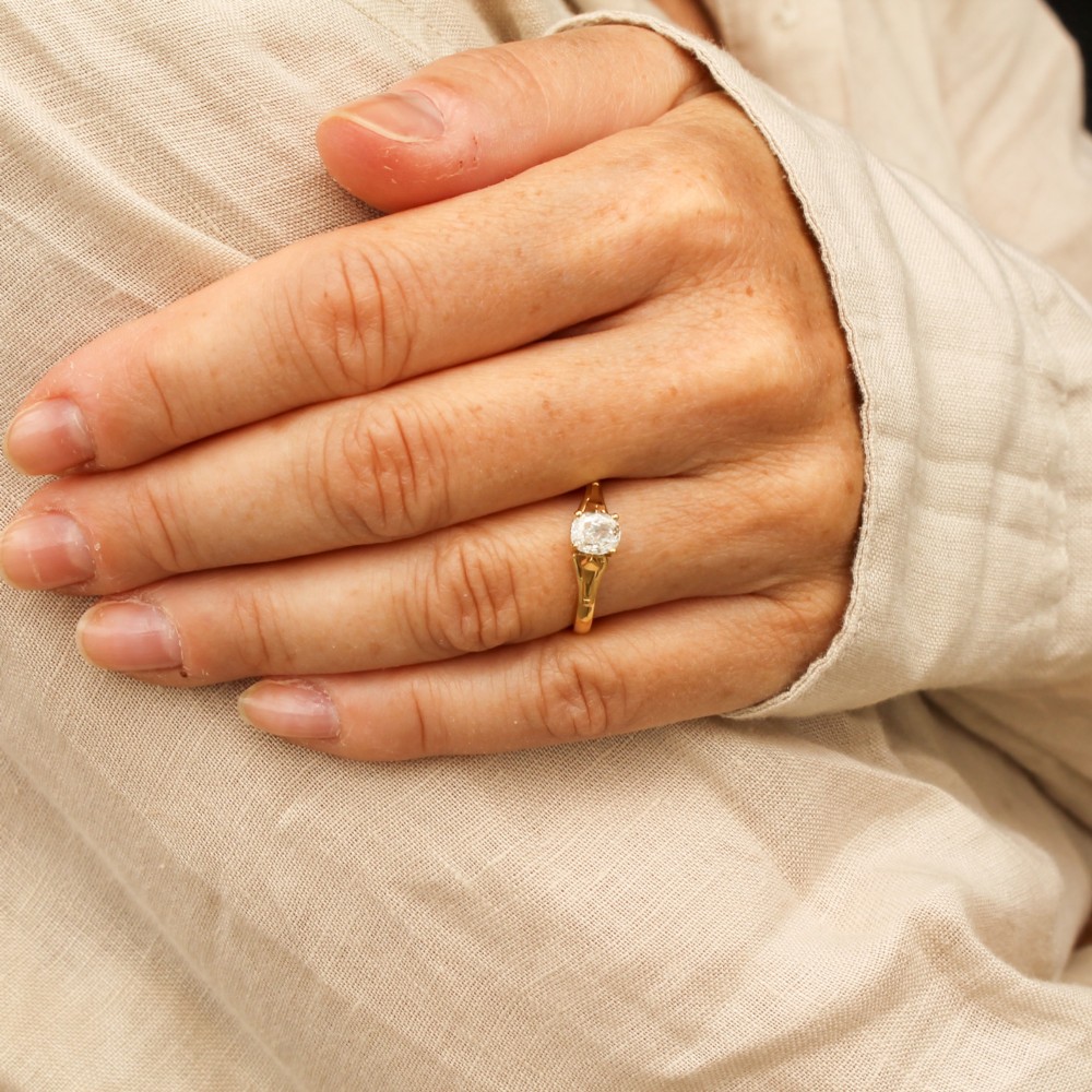An antique yellow gold solitaire ring featuring a single old cut diamond set in a claw mounting with split shoulders. View II