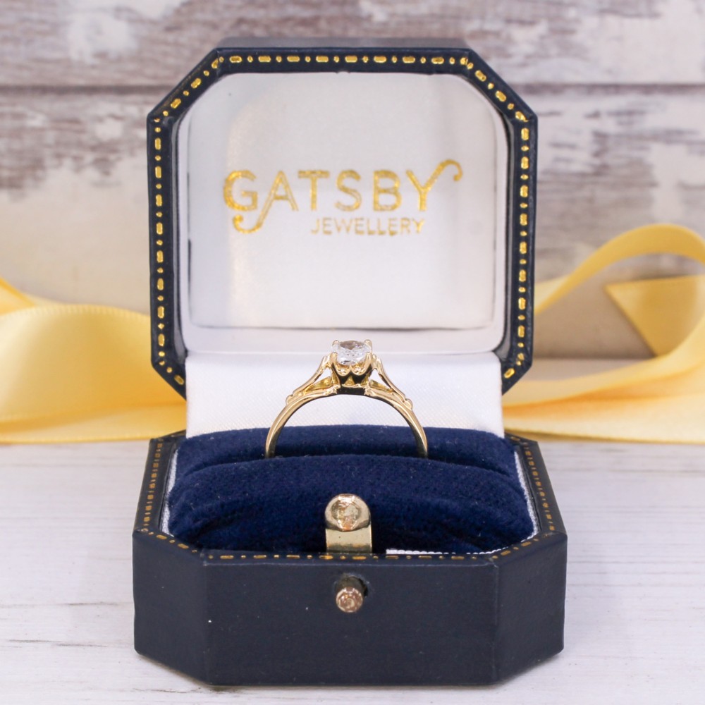 An antique yellow gold solitaire ring featuring a single old cut diamond set in a claw mounting with split shoulders. View IX