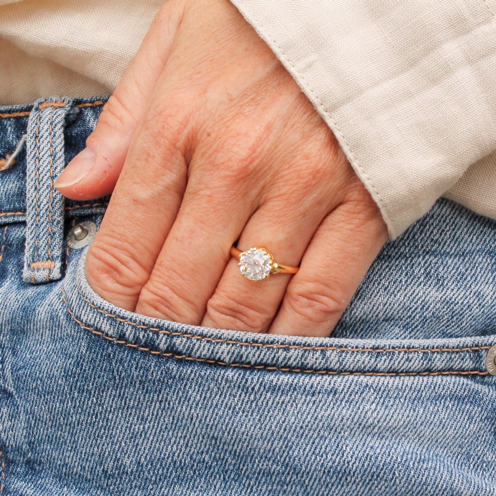 A vintage yellow gold engagement ring featuring a prominent round old cut diamond held in a multi-claw setting. View II