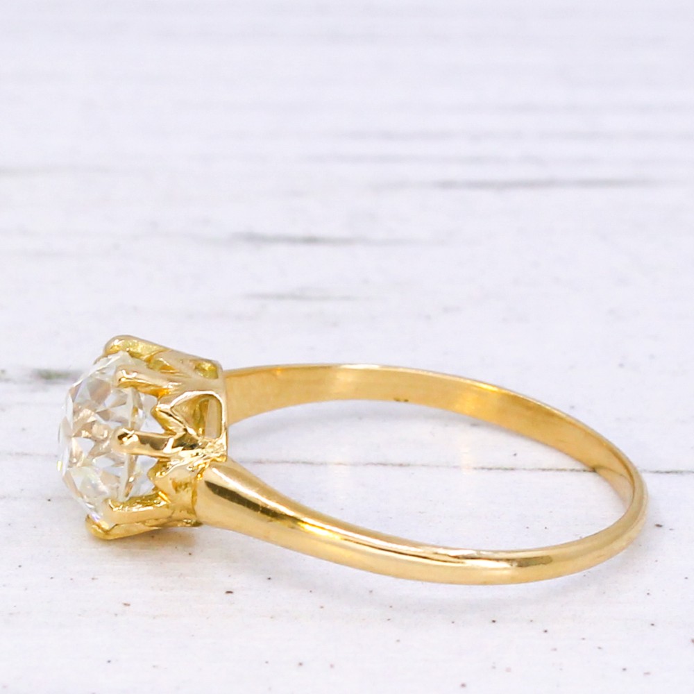 A vintage yellow gold engagement ring featuring a prominent round old cut diamond held in a multi-claw setting. View IV