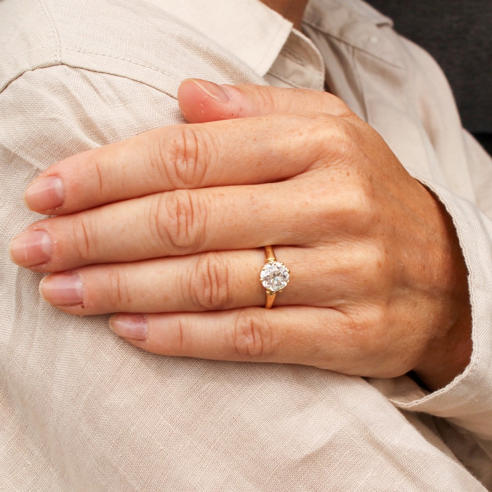 A vintage yellow gold engagement ring featuring a prominent round old cut diamond held in a multi-claw setting. View VI