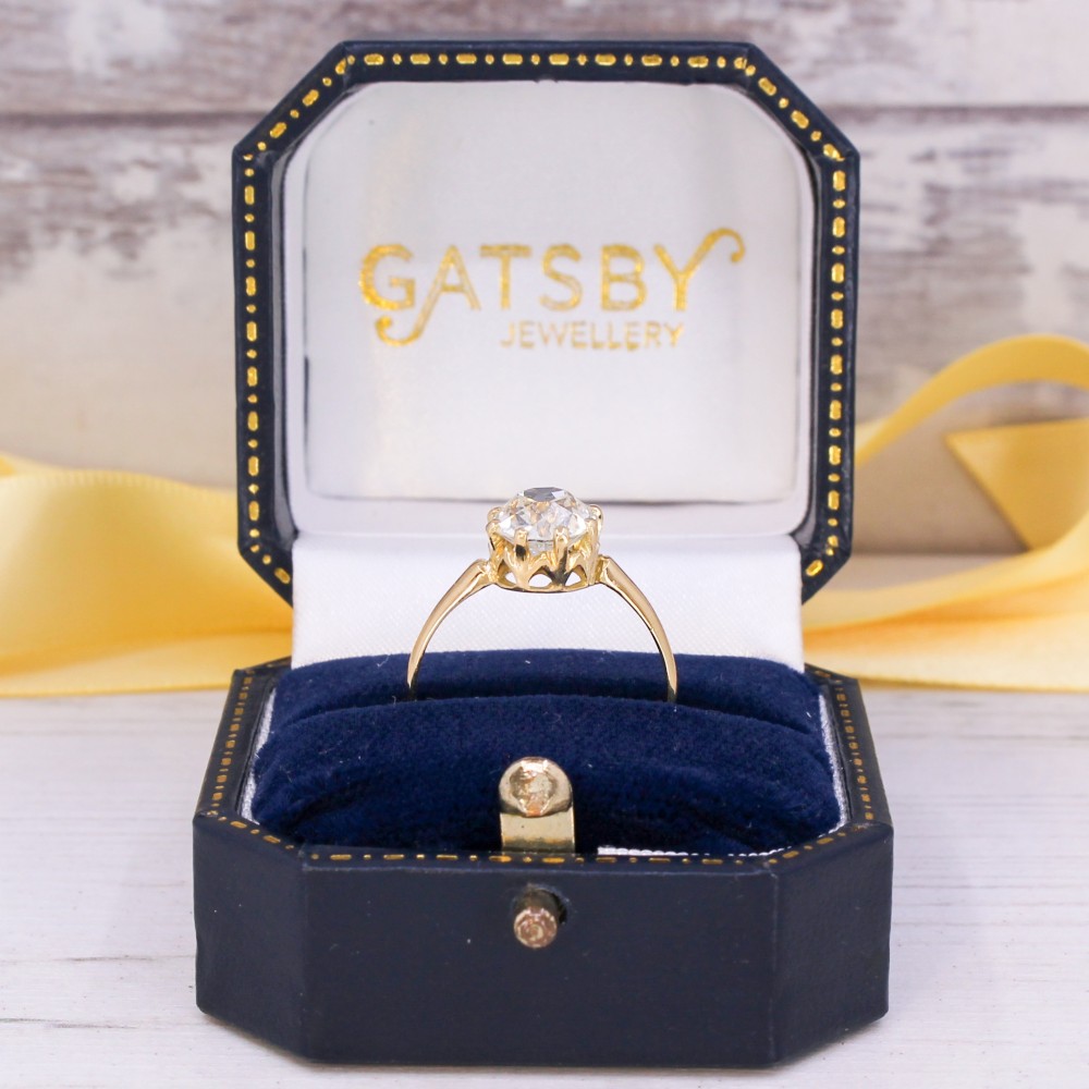 A vintage yellow gold engagement ring featuring a prominent round old cut diamond held in a multi-claw setting. View IX