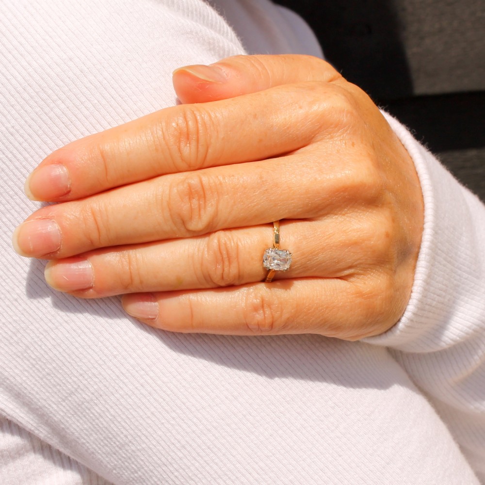 An antique gold engagement ring featuring an old mine cut solitaire diamond held in a claw setting. View VI