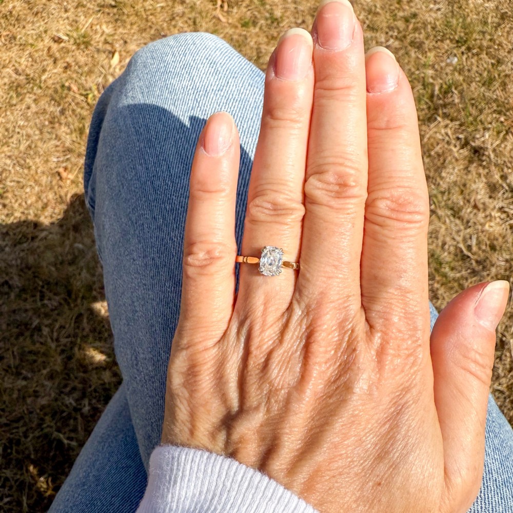 An antique gold engagement ring featuring an old mine cut solitaire diamond held in a claw setting. View VII
