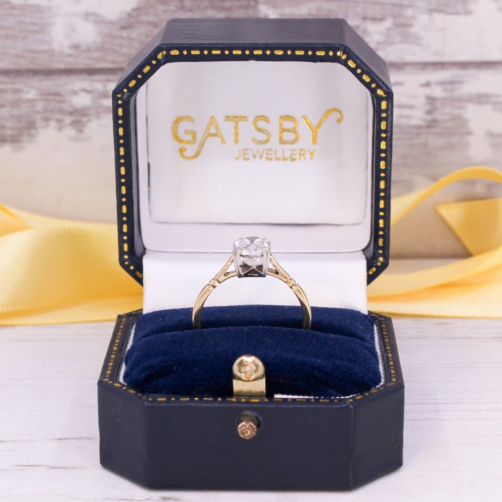 An antique gold engagement ring featuring an old mine cut solitaire diamond held in a claw setting. View IX