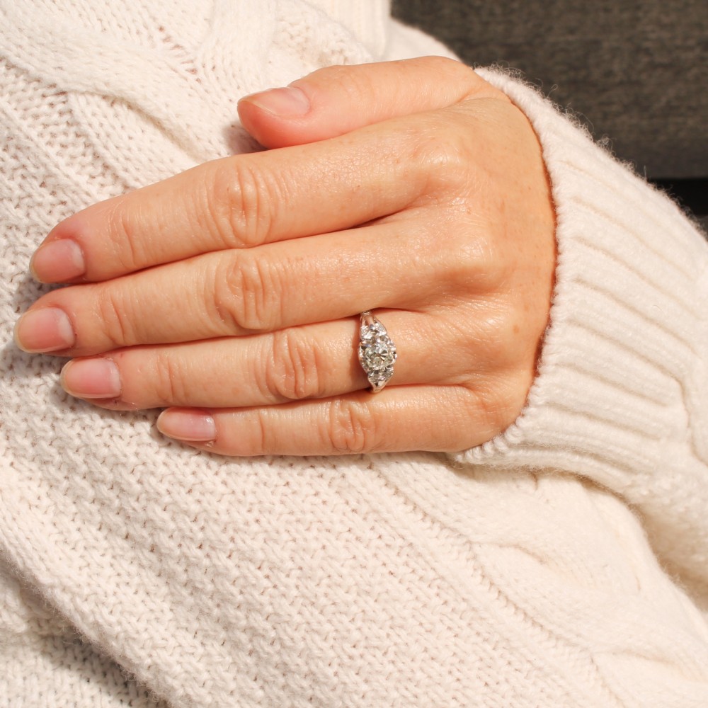 An Art Deco style white metal ring featuring a central old European cut diamond set in an ornate pierced basket setting. View VI
