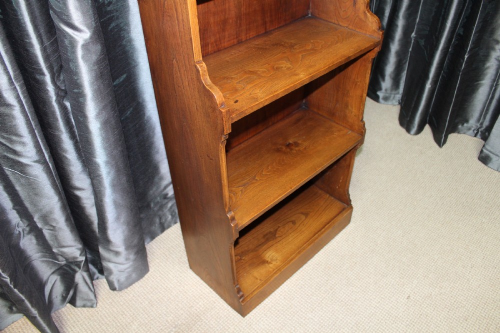 A tall antique elm open bookcase featuring seven shelves with decorative scalloped side profiles. View IV