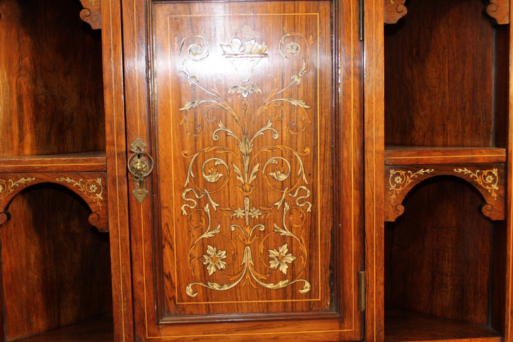 An antique dark wood corner display cabinet featuring delicate marquetry inlays, a glazed upper door, mirrored back sections, and open corner shelving. View III