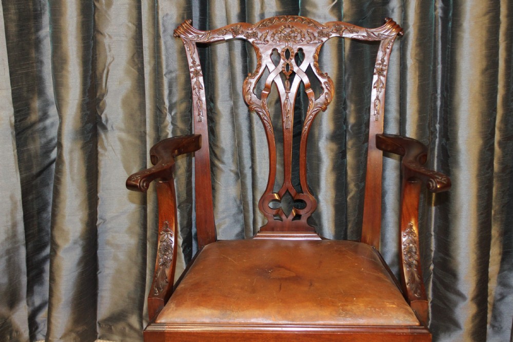 Set of eight mahogany Chippendale style dining chairs featuring carved pierced back splats, tan leather seats, and cabriole legs with ball and claw feet. View III