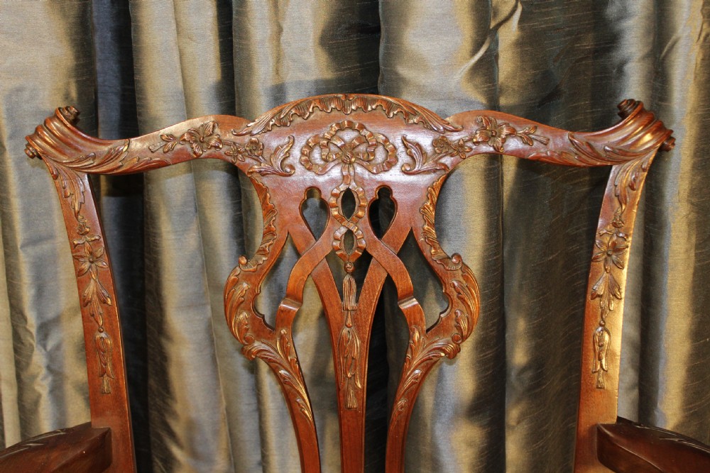 Set of eight mahogany Chippendale style dining chairs featuring carved pierced back splats, tan leather seats, and cabriole legs with ball and claw feet. View IV