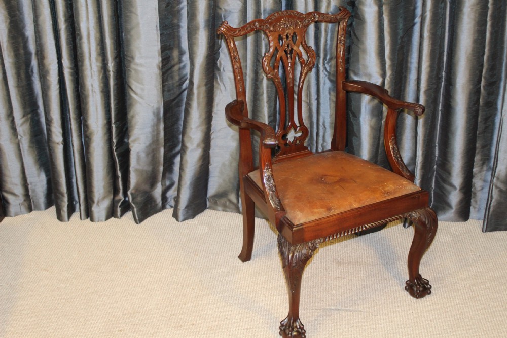 Set of eight mahogany Chippendale style dining chairs featuring carved pierced back splats, tan leather seats, and cabriole legs with ball and claw feet. View VI