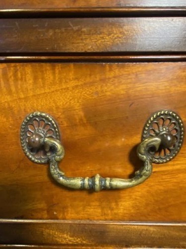 A mahogany chest of drawers featuring two short drawers above three long graduated drawers, fitted with brass swan-neck handles and raised on bracket feet. View II