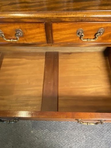 A mahogany chest of drawers featuring two short drawers above three long graduated drawers, fitted with brass swan-neck handles and raised on bracket feet. View III