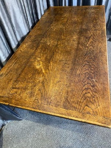 A solid oak refectory dining table featuring a broad rectangular top, twin turned pillar supports, and a floor-level stretcher base. View III