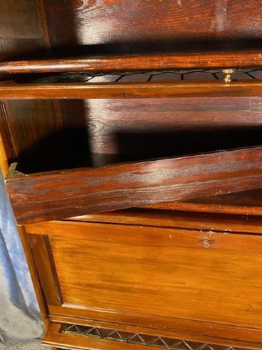 A tall dark mahogany sectional barrister bookcase with five leaded glass door compartments and a central wooden drop-front panel. View VII