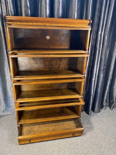 A four-tier warm brown oak barrister bookcase featuring glazed lift-and-slide doors and a single bottom drawer. View II