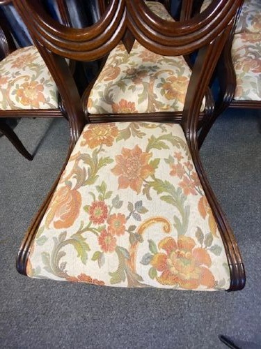 A set of six carved mahogany dining chairs featuring openwork backrests and floral patterned upholstered seats. View III