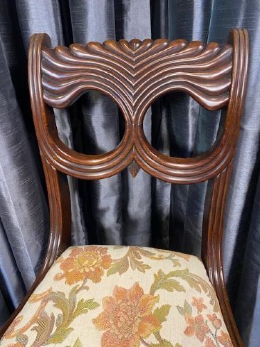 A set of six carved mahogany dining chairs featuring openwork backrests and floral patterned upholstered seats. View IV