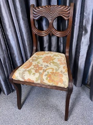 A set of six carved mahogany dining chairs featuring openwork backrests and floral patterned upholstered seats. View VI