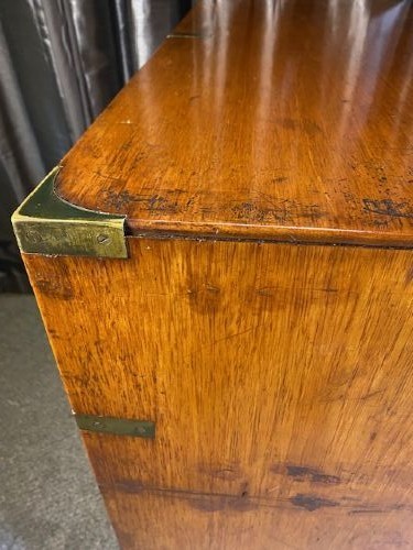 A nineteenth-century mahogany military campaign chest of drawers featuring flush brass handles, protective corner mounts, and turned feet. View VII