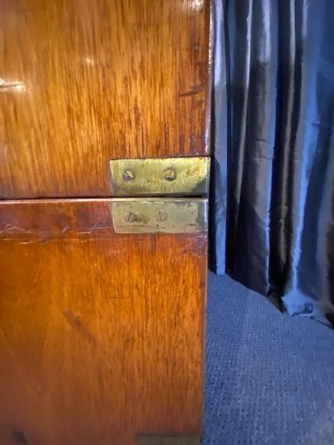 A nineteenth-century mahogany military campaign chest of drawers featuring flush brass handles, protective corner mounts, and turned feet. View VIII
